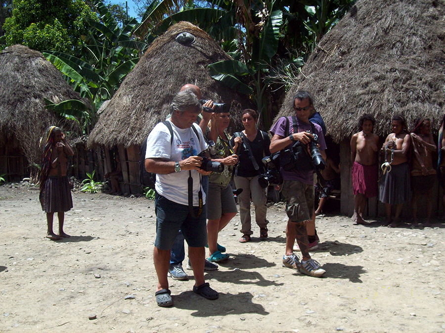 Tourists visit a village in Baliem Valley