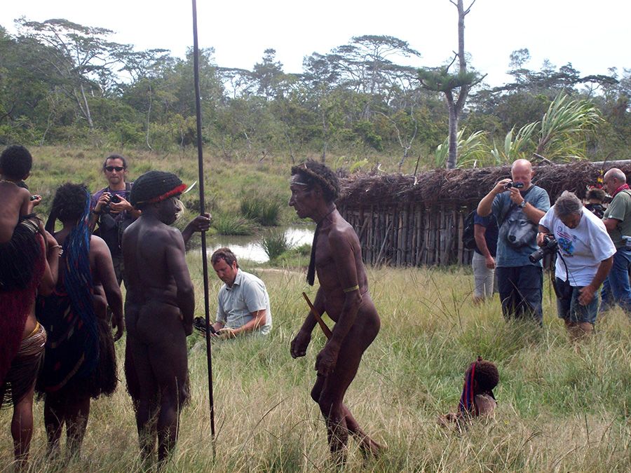 Tourists and villagers in a Baliem Valley tour